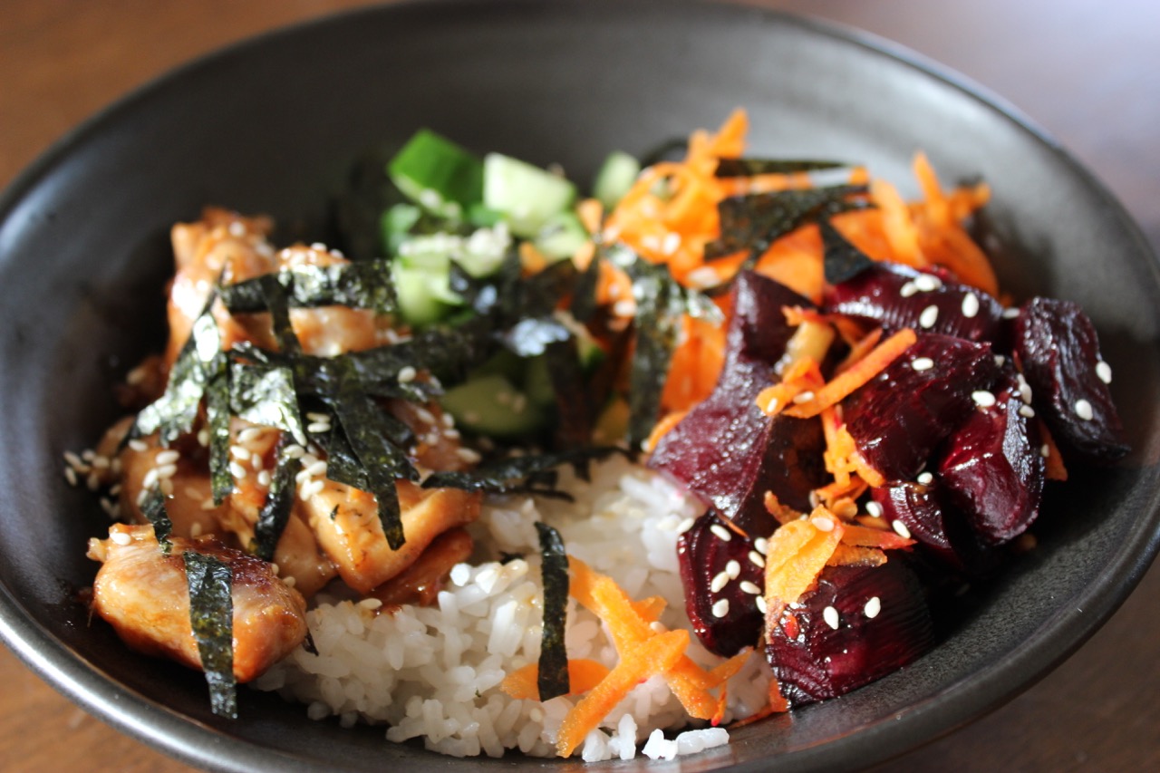 healing chicken, vegetable and rice bowl with seaweed flakes on top